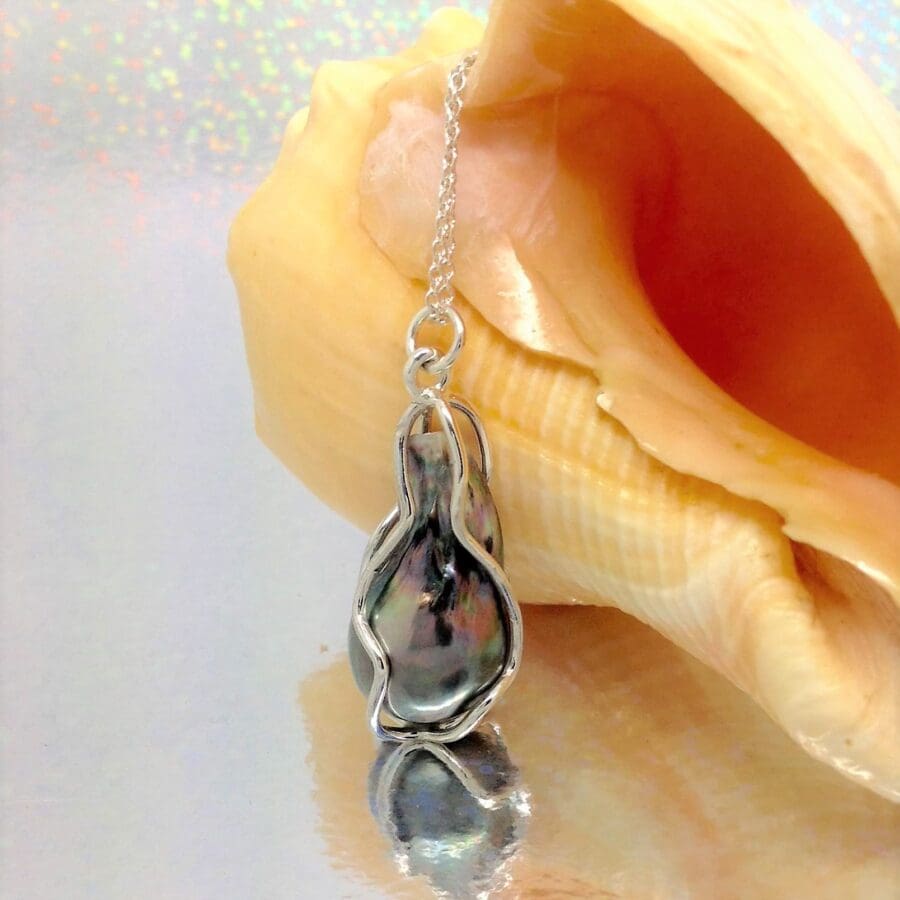 803 Pearl Wrapped In A Custom Silver Cage Commission