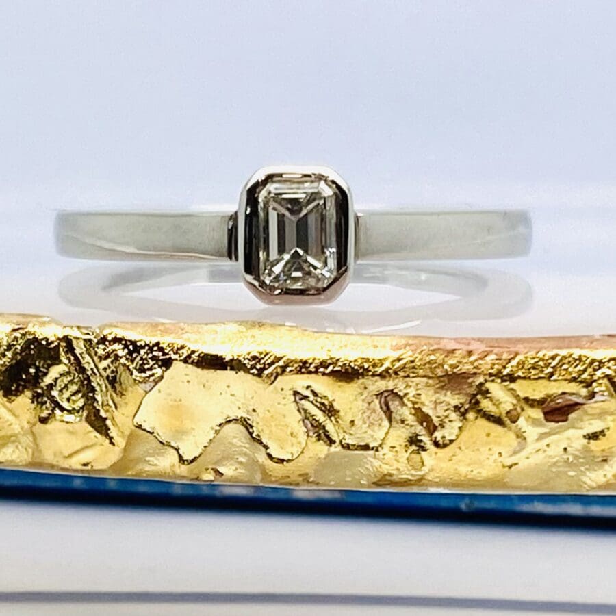 12600093 Platinum Emerald Cut Rub Over Solitaire Engagement Ring