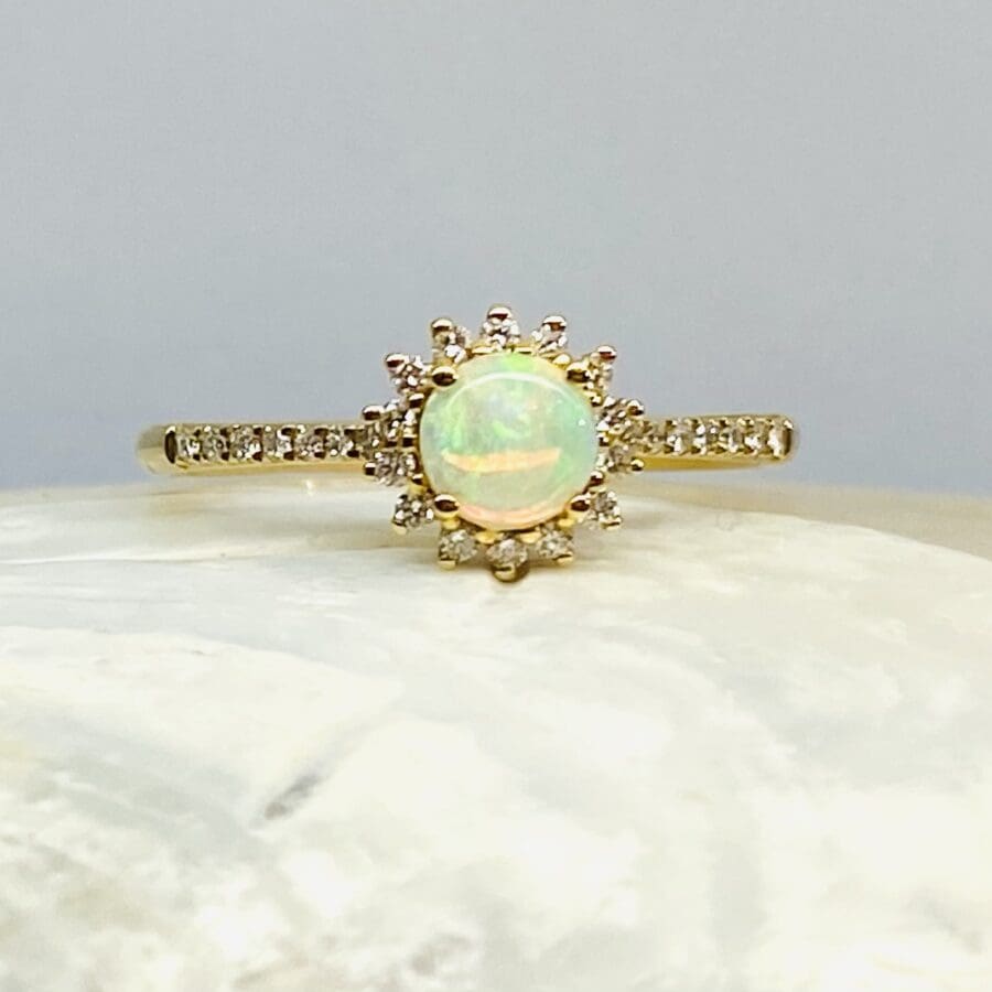 15600056 18ct Yellow Gold Opal And Diamond Halo Dress Ring